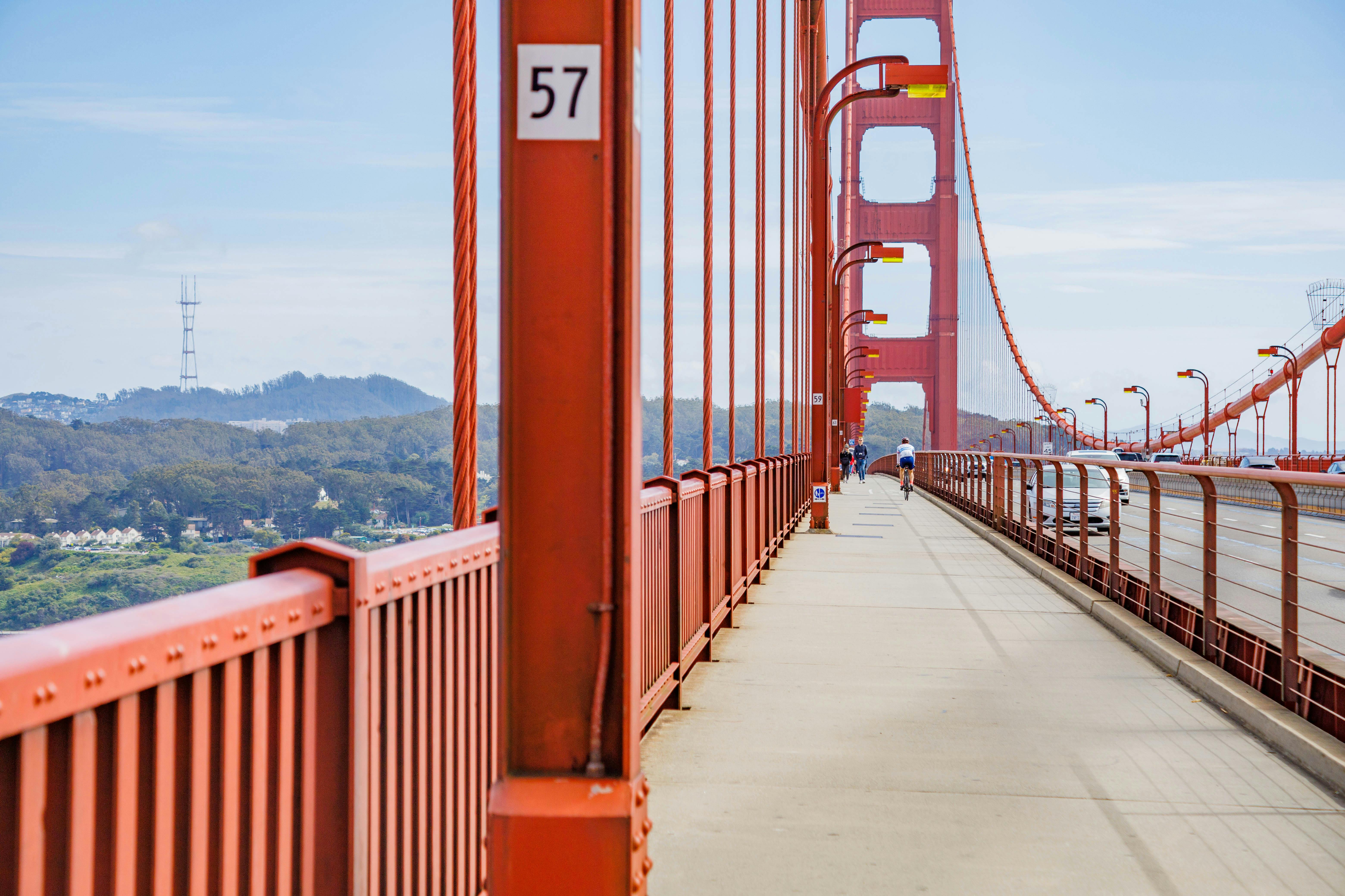 A road bike leaning against a wooden fence with the California coast in the background